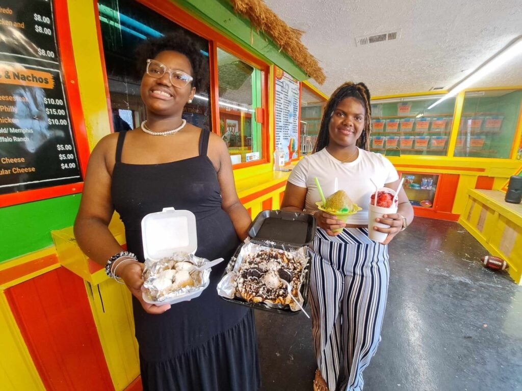 County high school students Kimoree, Malia Houston make dishes at father’s business Carnival Treats
